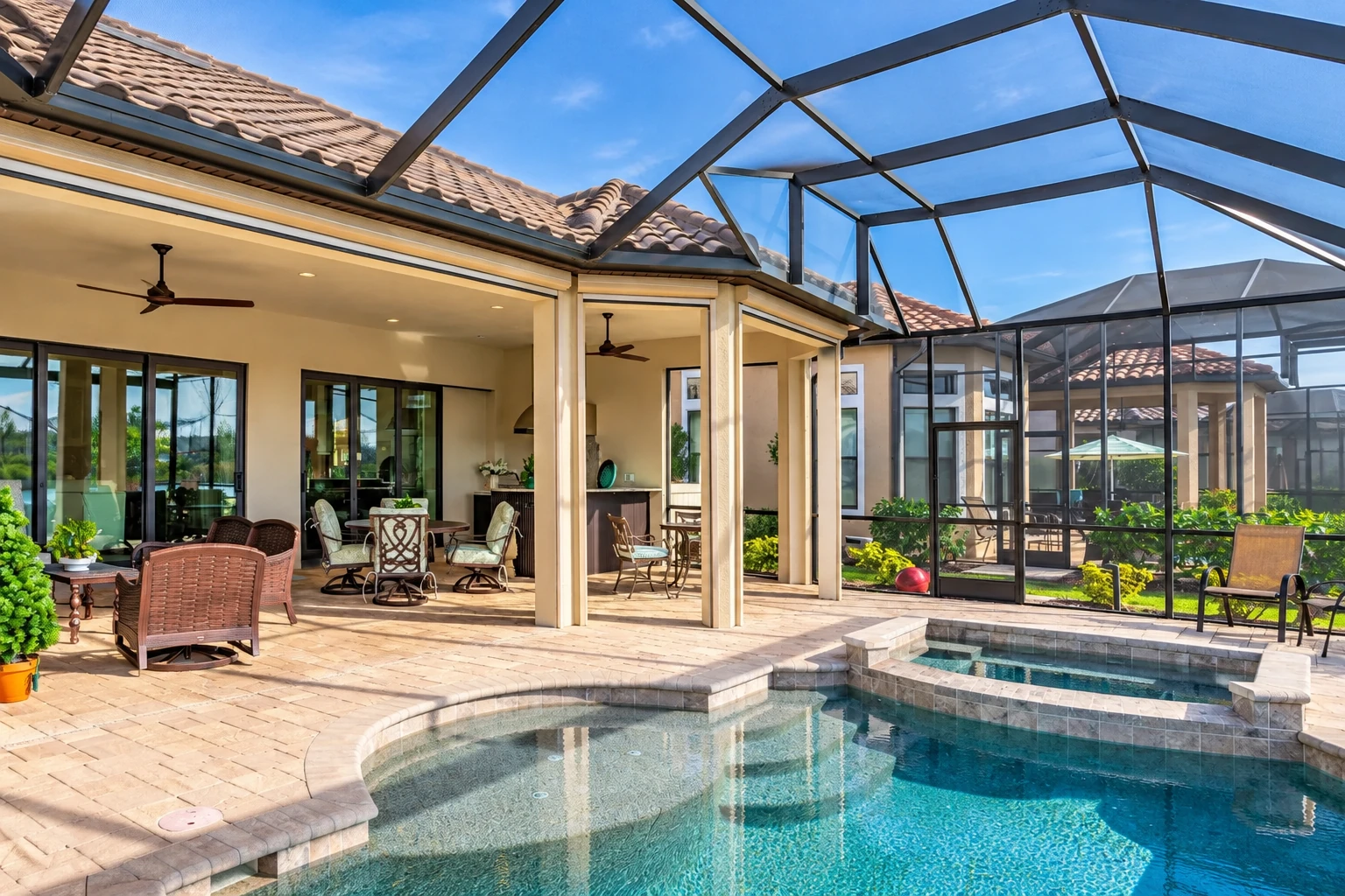 A dark-framed patio cover shelters a tiled outdoor seating area beside a swimming pool and screened enclosure.